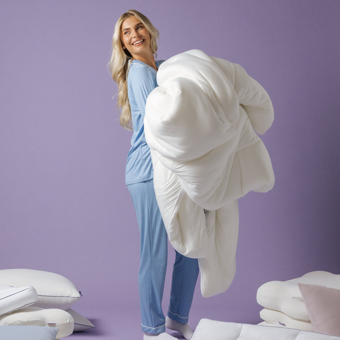 a woman holding a comforter